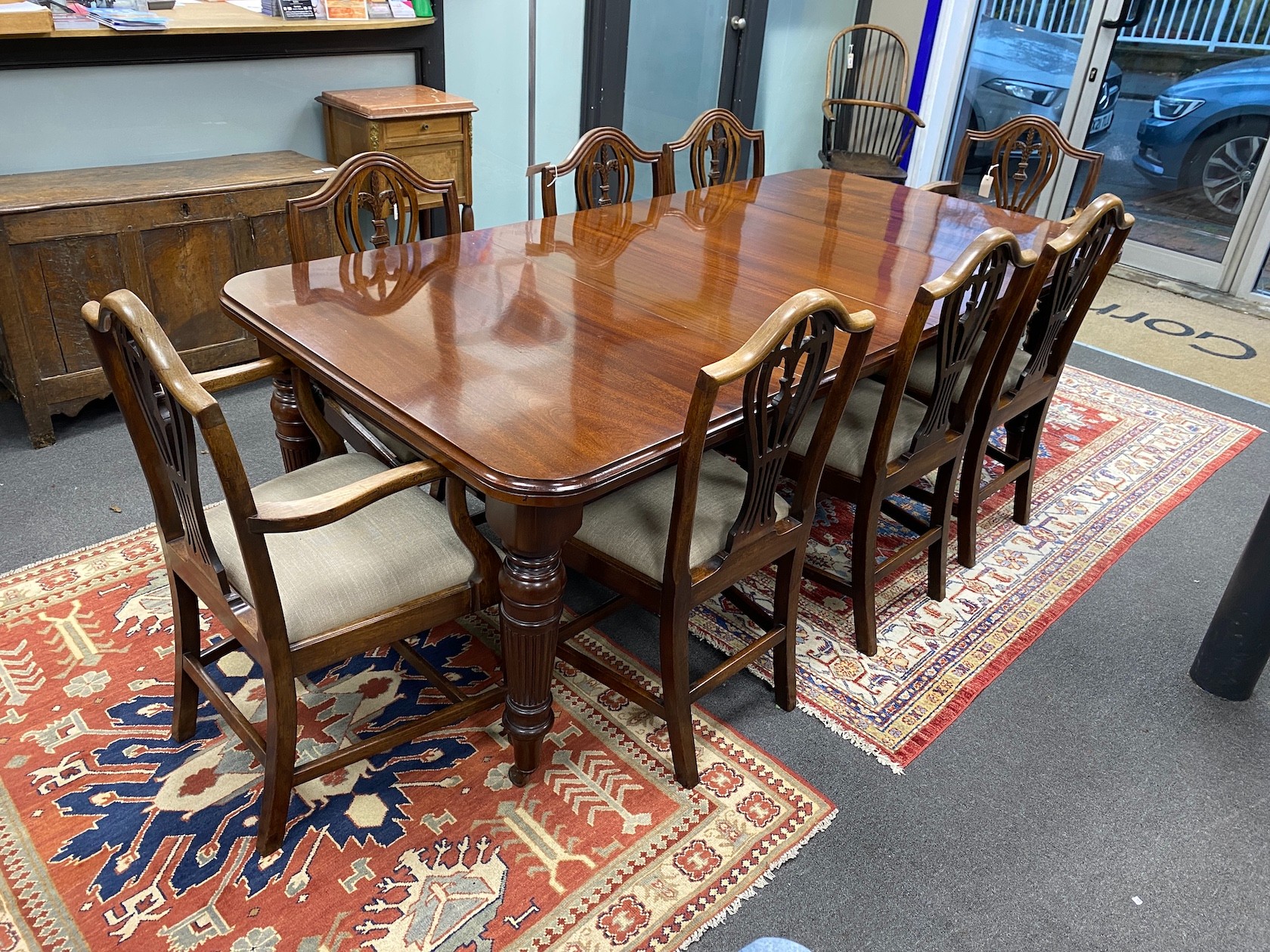 A late Victorian mahogany extending dining table, length 209cm extended with two spare leaves and winder, depth 106cm, height 76cm together with a set of eight Hepplewhite style dining chairs, two with arms